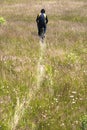 ÃÂ¡yclist rides through meadow with uncut yellowed grass