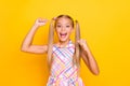 Yeah. Photo of funny crazy little lady schoolgirl raise fists supporting classmates team sports match wear checkered