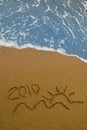 Year 2010 written on sand