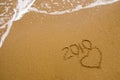 Year 2010 written on sand