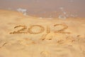 Year 2012 written in sand