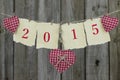 Year 2015 on antique paper with red hearts hanging on clothesline by wood fence Royalty Free Stock Photo