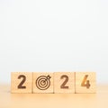 2024 year block with dartboard icon. Goal, Target, Resolution, strategy, plan, Action, mission, motivation, and New Year start