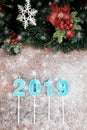 Year 2019 in blue color on wooden board and blurry showflake, bo