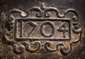 Year 1704 carved on a rusty iron surface Royalty Free Stock Photo