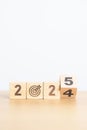 2024 year change to 2025 year block with dartboard icon. Goal, Target, Resolution, strategy, plan, Action, mission, motivation,