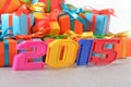 2015 year colorful figures on the background of gifts Royalty Free Stock Photo