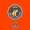 Year of the dog logo. 2018. A cute and cheerful dog in a badge with letters.