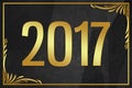 Year 2017 gold word on black wrinkled paper background