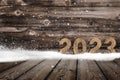 Year 2023 made of wood in snow Royalty Free Stock Photo