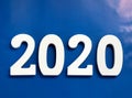 Year 2020 made from wooden white numbers on a blue background