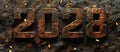 2028 Year Numbers in Rusty Metal on Dark Textured Background with Golden Bokeh Lights Royalty Free Stock Photo