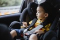 1 Year Old Adorable Asian Boy Alone Looking Around From Car Seat in the Car Royalty Free Stock Photo