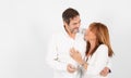 A 50-year-old adult couple poses in a photographic studio in a cheerful way with a white background