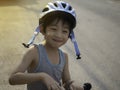 A 4-year-old Asian boy smiled happily with the opportunity to exercise by riding a scooter