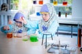 A 6 and 4 year old Asian girl wearing a blue Islamic dress Learning And conducted a scientific experiment Royalty Free Stock Photo