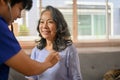 60-year-old Asian retried woman is being measured for her heart beat by a doctor Royalty Free Stock Photo