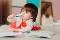1 year old baby girl drawing with pencils at home Royalty Free Stock Photo