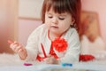 1 year old baby girl drawing with pencils at home Royalty Free Stock Photo