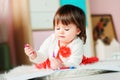 1 year old baby girl drawing with pencils at home Royalty Free Stock Photo