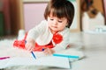 1 year old baby girl drawing with pencils at home Royalty Free Stock Photo