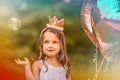 3-year-old birthday girl with soap bubbles and balloons outdoors Royalty Free Stock Photo