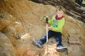 5 year old blond boy playing on a mound of dirt without hygiene digging holes Royalty Free Stock Photo