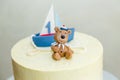 1 year old boy birthday cake with boat and sailor teddy bear for sea party Royalty Free Stock Photo