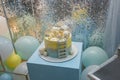 1 year old boy birthday cake standing on blue cube. Clouds, stars toppers with date and weight of baby, teddy bear on top of cake Royalty Free Stock Photo