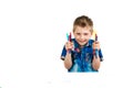 A 6 year old boy in a blue shirt paints with pencils on a white background isolate Royalty Free Stock Photo