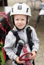 5-year-old boy in a helmet and equipment for mountaineering