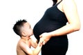 4 year old boy kissing pregnant belly of his mom Royalty Free Stock Photo