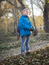 A 7-year-old boy is lit by the setting sun in an autumn park