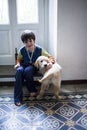 6 year old boy with his golden retriever puppy dog at home Royalty Free Stock Photo