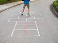 8 year old boy playing hopscotch Royalty Free Stock Photo