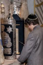 14 year old boy practicing for his Bar Mitzvah reading Torah scroll Royalty Free Stock Photo