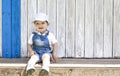 2 year-old boy sitting portrait at wooden beach hut Royalty Free Stock Photo