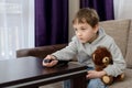 7 year old boy sitting on the sofa and watching tv. Royalty Free Stock Photo