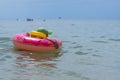 A 3-year-old boy swims in the sea in a life jacket and rubber ring. Persons not visible. Early morning Royalty Free Stock Photo