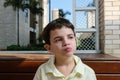 7 year old Brazilian child, on a sunny afternoon, chewing the chocolate with his mouth closed and looking to the side. Royalty Free Stock Photo