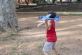 10 year old Brazilian child playing with his Styrofoam plane on a sunny afternoon_5