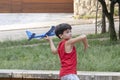 10 year old Brazilian child playing with his Styrofoam plane on a sunny afternoon_9