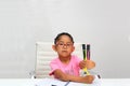 4-year-old brunette Latina girl with autism spectrum disorder ASD like Asperger, Rett and Heller draws at a desk, plays with color Royalty Free Stock Photo