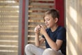 An 11 year old Catholic boy reads the rosary prayer, holds a wooden rosary with 10 beads in his hands. Royalty Free Stock Photo