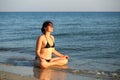35 year old caucasian woman doing yoga at the sunset sea shore. Body positive Royalty Free Stock Photo
