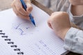 4-year-old Child drawing graphic dictation in checkered notebook, Connecting dots into picture, Motor Skill Improvement