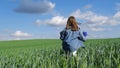 An 11-year-old child girl runs across a field with tall green grass. Free happy child. Royalty Free Stock Photo