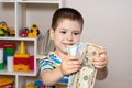 A 4-year-old child learns to count money. Financial literacy and investment education for children