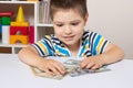 A 4-year-old child learns to count money. Financial literacy and investment education for children