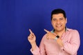 40-year-old Latino man points with the fingers at something that he likes, surprises and excites such as products and promotions Royalty Free Stock Photo